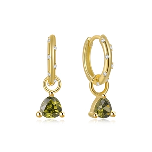 Detail of gold hoop earrings with white zircons and a green triangular gemstone drop