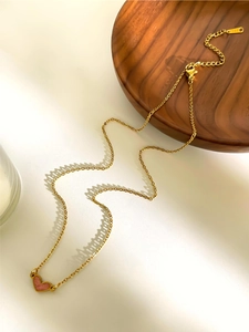 Detail view of pink heart pendant necklace with lobster clasp and extension chain