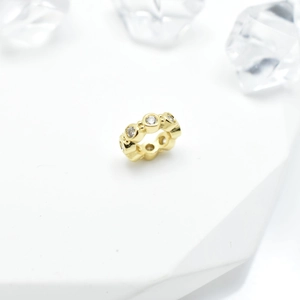 Gold plated bead with micro-set zircons for DIY jewelry making on white display