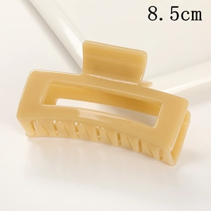 Detail view of a stylish matte rectangular hair claw clip in beige, perfect for everyday chic updos.