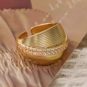 Detailed macro view of 18K gold plated wide band ring with layered zircon and vintage texture