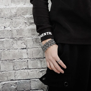 Detail of vintage carved silver steel bracelet with thick chain links on male wrist