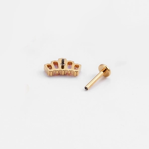 Detailed macro view of golden crown labret with pink opal stone and flat back post