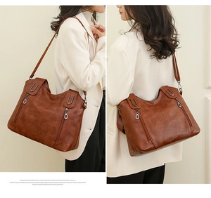 Detail view of brown vintage soft leather tote bag showing front and back perspectives
