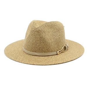 Classic Panama straw hat with elegant beige leather band and golden metallic buckle detail
