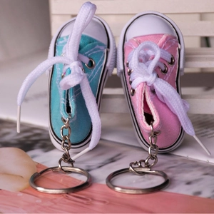 Mini canvas sneaker keychains in light blue and pink with rubber soles and metal rings