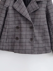 Detailed view of grey glen plaid blazer featuring classic double-breasted four-button design