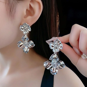 Silver double layer flower drop earrings with crystals on a female model