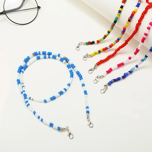Detail of colorful beaded mask and glasses chains with silver metal lobster clasps