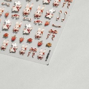 Close-up of 5D embossed nail stickers featuring vintage rabbits, strawberries and roses