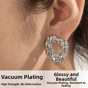 Close-up of silver irregular geometric earrings with molten lava texture on model
