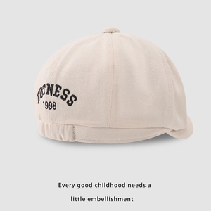 Detail of beige cotton kids cap with BONNESS 1998 embroidery and elastic back strap