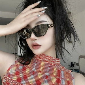 Women's black narrow cat eye sunglasses with gold chain detail on temples