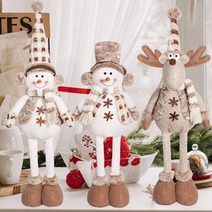 Three plush Christmas figurines including reindeer and snowmen with knit hats and scarves