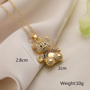 Detail shot of a gold-plated bear pendant with multicolored zircons and dimensions