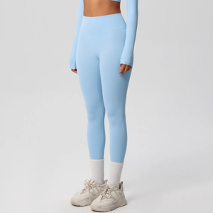 Close-up of light blue yoga leggings with high waist and sleeve cuffs with thumb holes