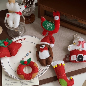Detailed view of handmade Christmas felt ornaments with reindeer and star embroidery