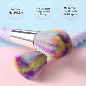 Unicorn makeup brush set with rainbow bristles and purple spiral handle on pastel background