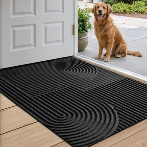 Non-slip black entryway mat with ripple texture shown on wood floor by a white door