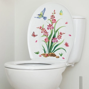 Detail of floral toilet sticker featuring pink orchids and a hummingbird on white lid