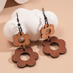 Macro view of bohemian hollow flower wooden earrings with vintage brown wood grain details