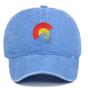 Detailed close-up of Colorado flag embroidery on washed blue cotton twill baseball cap