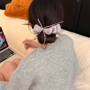 Detail of lavender chiffon bow hair clip with zircon star on model's hairstyle