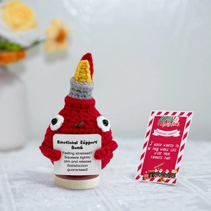 Handmade red crochet bomb doll with a Christmas message card and festive gift tag