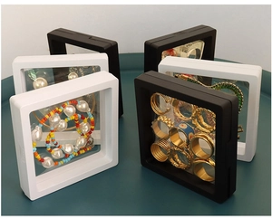 Close-up of black and white square PE film suspension boxes for jewelry display