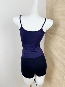 Close-up of dark blue ribbed knit tank top and black shorts on a mannequin