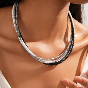 Close-up of multi-layer glass seed bead necklace in bohemian black and silver tones