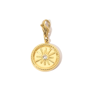 Detailed view of a gold sunburst pendant with a center zircon and lobster clasp