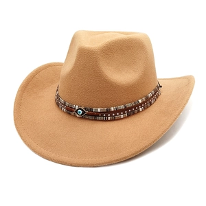 Detail of camel wool fedora featuring ethnic ribbon, rivets and Evil Eye charm