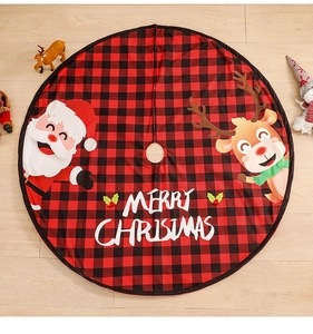 Detail of red and black plaid Christmas tree skirt with Santa and reindeer motifs