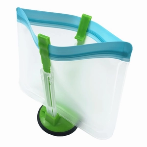 Detail view of a green foldable stand holding an open reusable PEVA food storage bag
