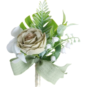Champagne satin rose boutonniere with green leaves and ribbon for wedding ceremony