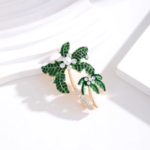 Elegant gold-tone coconut tree brooch with green enamel, rhinestones, and white pearl inlay