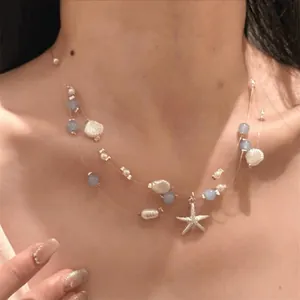 Three-layer ocean style necklace with blue beads, white shells and a silver starfish