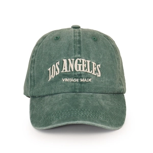 Close-up of vintage green baseball cap with white LOS ANGELES 3D embroidery detail