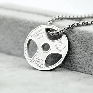 Detail of silver dumbbell pendant necklace featuring an engraved motivational quote