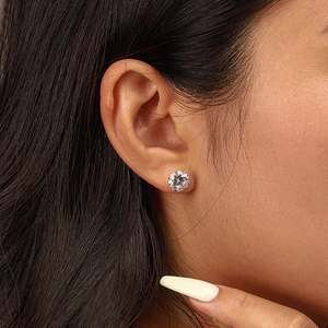 Close-up of S925 sterling silver stud earrings with sparkling round cubic zirconia on ear