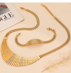 Macro detail of gold-plated collar necklace and bracelet set with 925 silver stamp