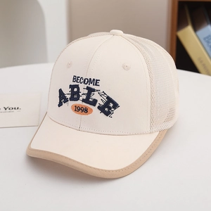 Detail of kids baseball cap featuring breathable mesh and 3D letter embroidery in cream