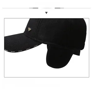 Detailed macro view of the black thermal baseball cap with metal logo and SPORT embroidery