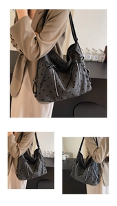 Detail of dark grey tote with black polka dots, bow accent, and vertical silver zippers