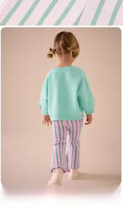 Girls' casual outfit featuring mint green sweatshirt and pink striped flare leggings
