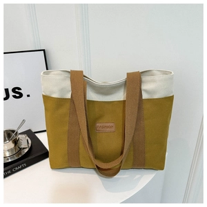 Detail of canvas tote bag with fashion patch, yellow and cream patchwork design