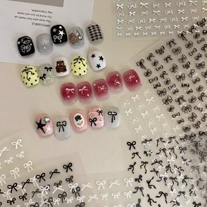 Elegant bow nail art stickers and decorative press-on nails set with metallic patterns