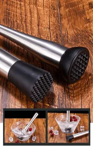 Macro shot of stainless steel cocktail muddler with textured black crushing head on wood