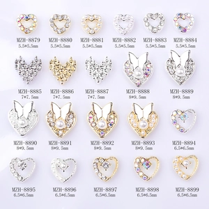 Assorted alloy heart and butterfly nail art charms with pearls and rhinestones